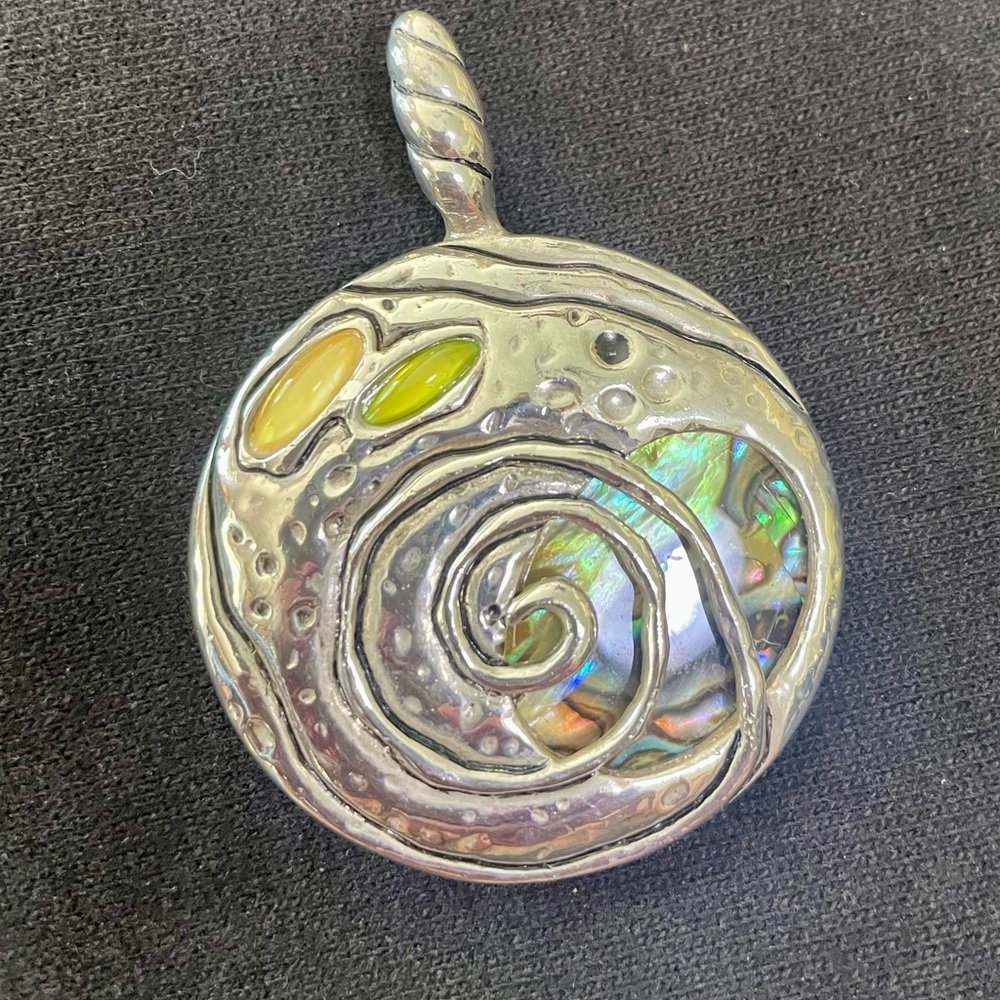 Silver pendant for necklace abalone shell background